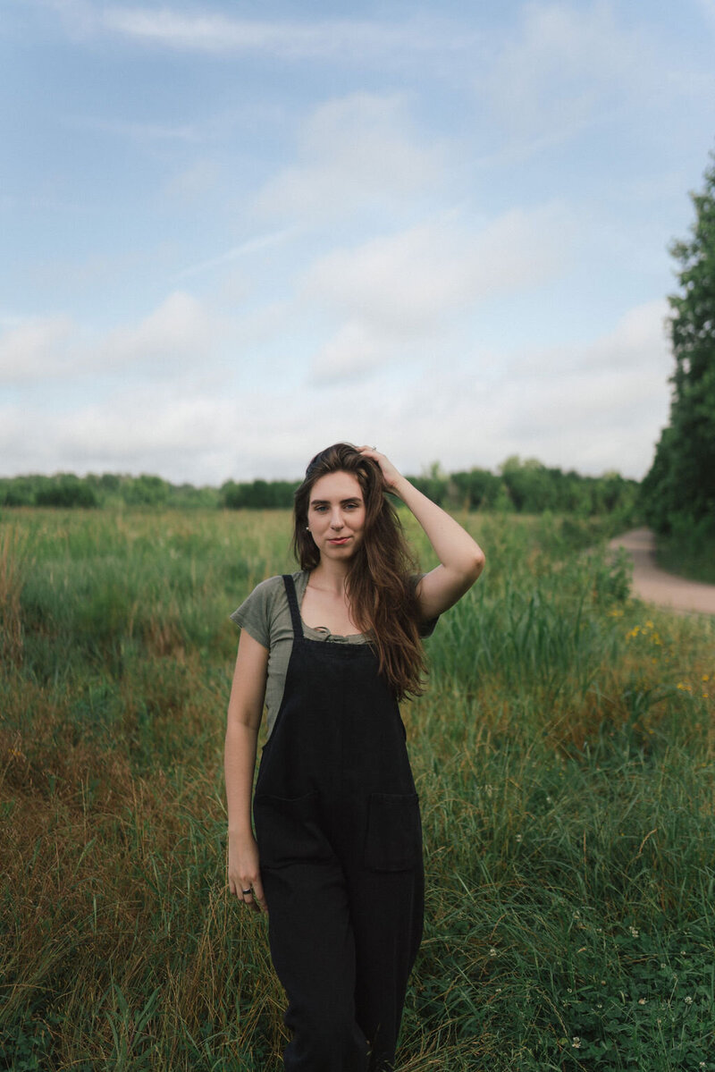 Woman stands in field at Seven Islands Birding Park in Kodak, Tennessee