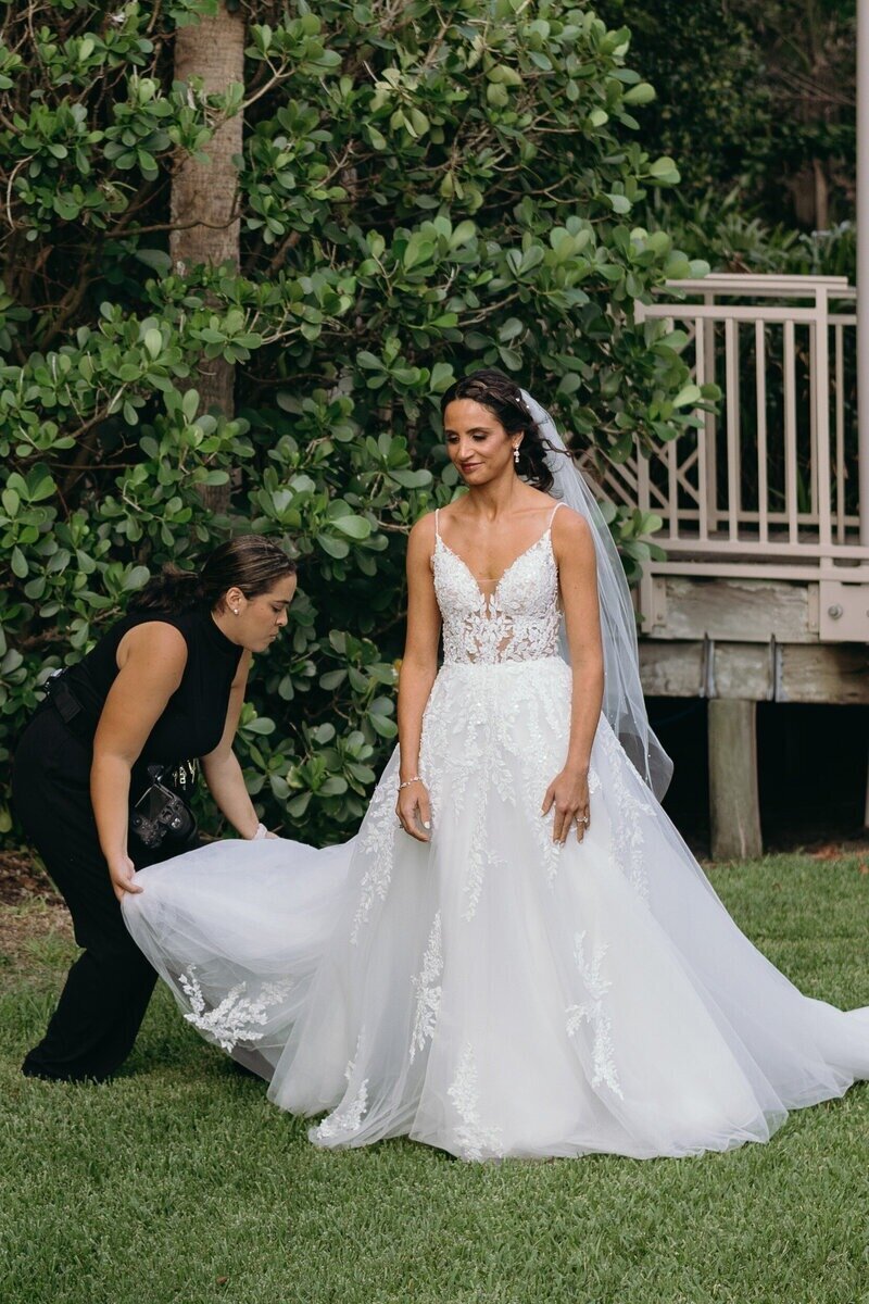 Bride getting her wedding dress prepped, wedding photography in Tampa captured by Priscila Del Cristo.