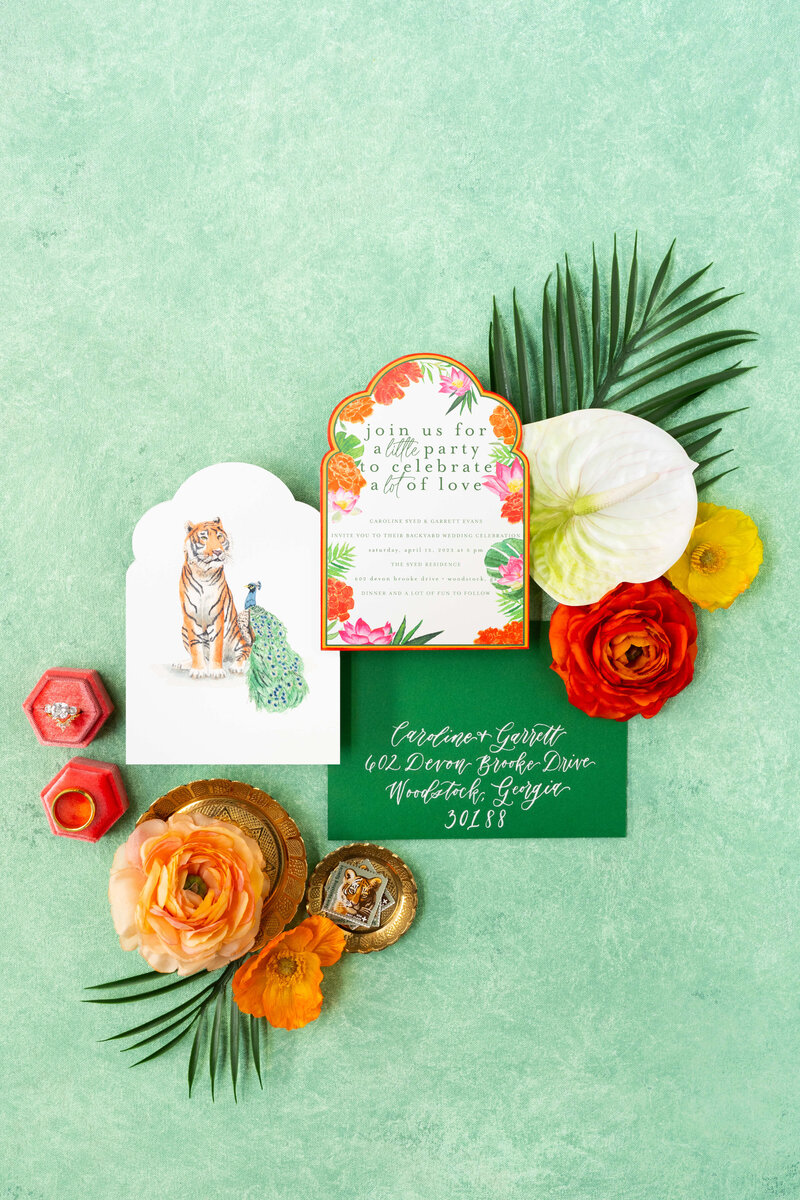 Indian wedding invitations featuring vibrant colors, boho details, and a unique arched invitation design adorned with watercolor florals