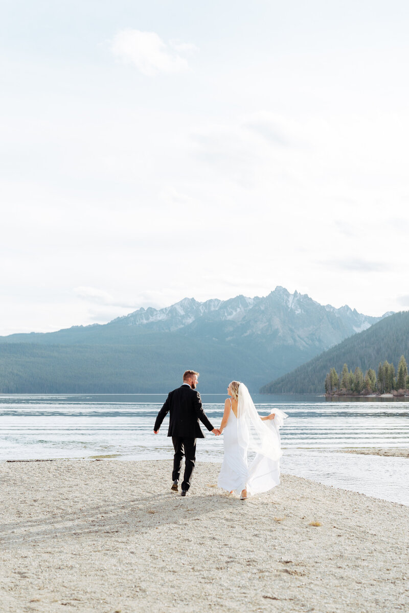 Bride and groom during wedding golden hour portrait session at Redfish Lake, Stanley, Idaho wedding - photographed by The Storytellers
