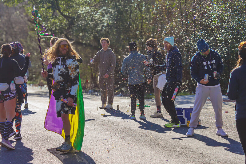 Group of marathon runners and a cheering crowd mid-race in colorful athletic gear, capturing dynamic movement and energy.