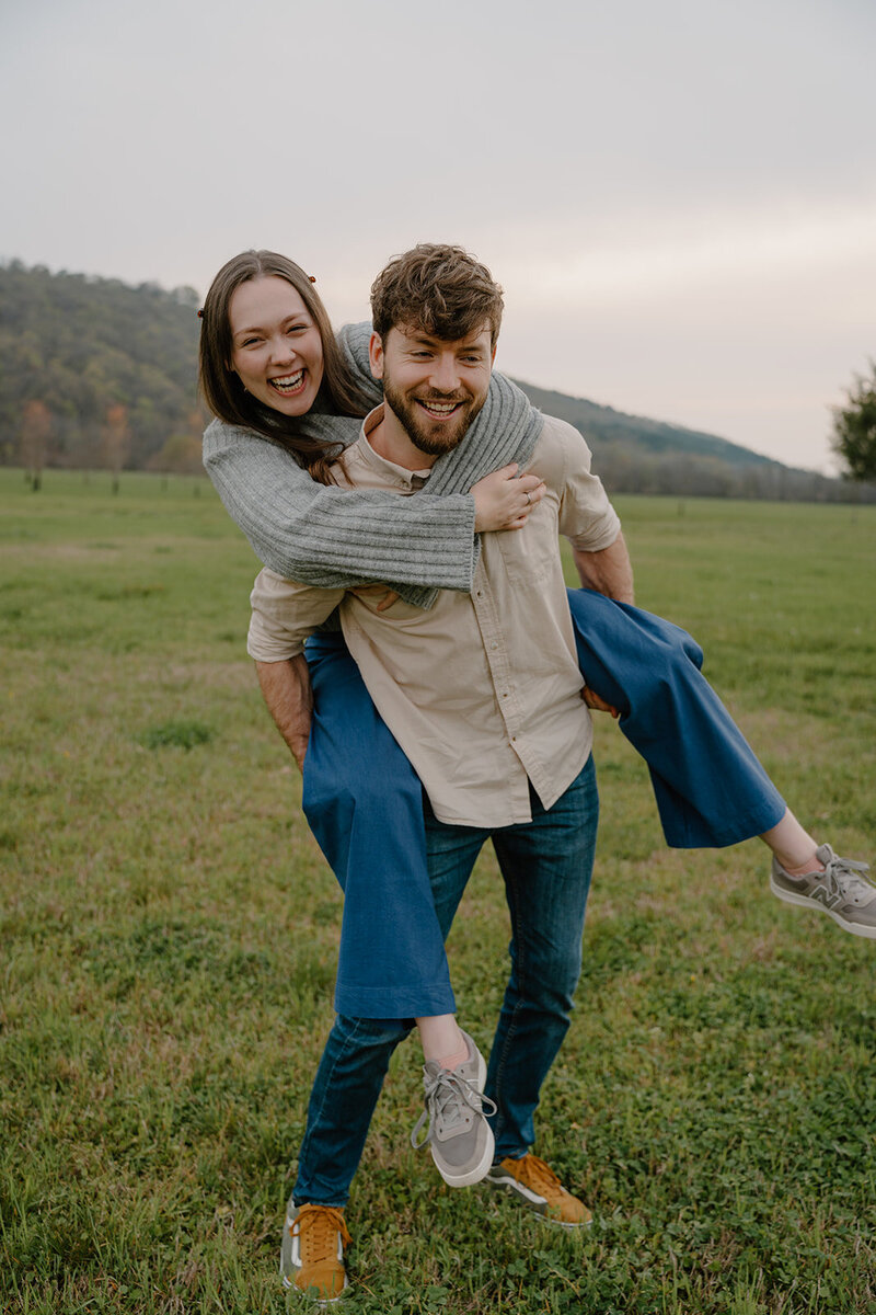 couples photo of a piggy back ride during a photo session