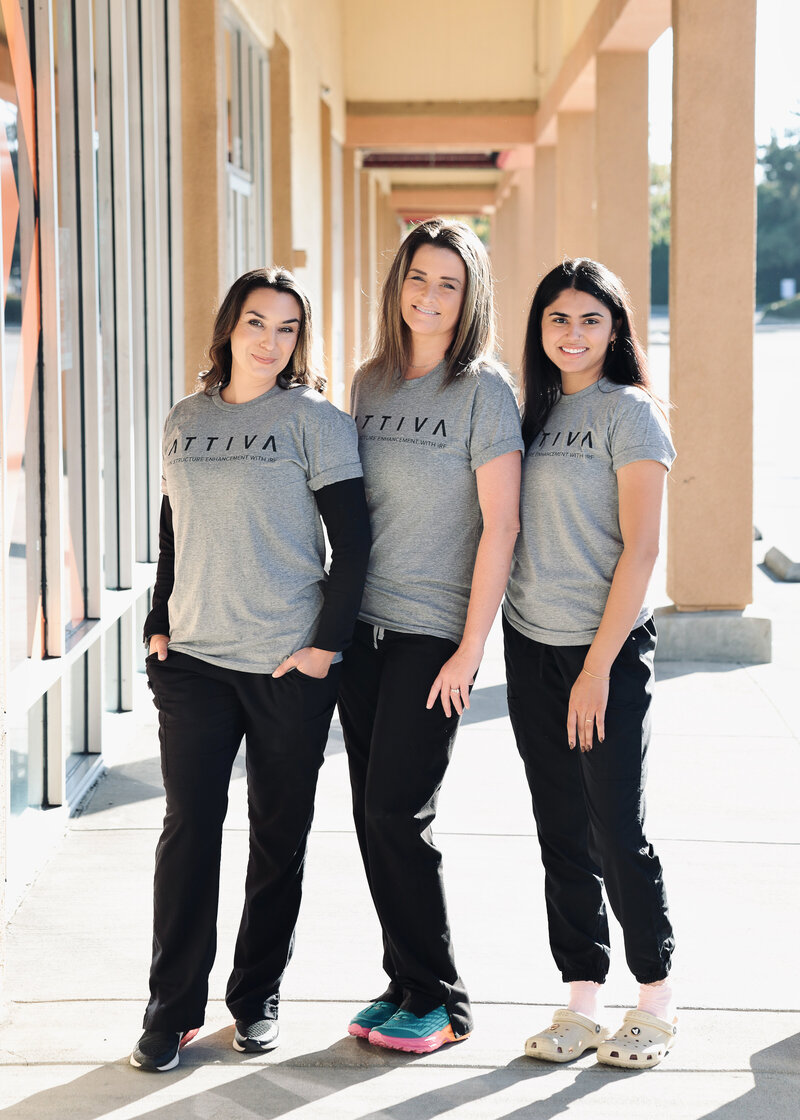three ladies in black pants and gray Attiva  tshirts