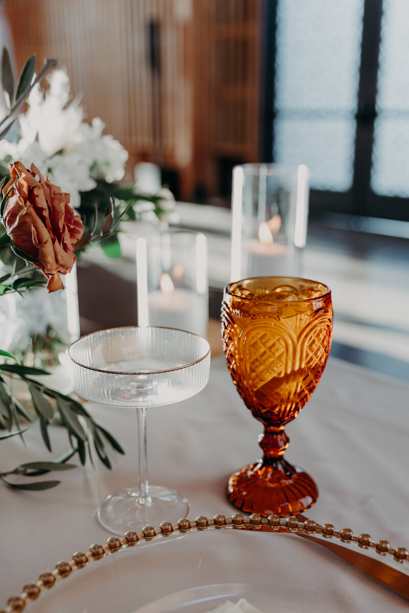 two glasses at sweetheart table at wedding