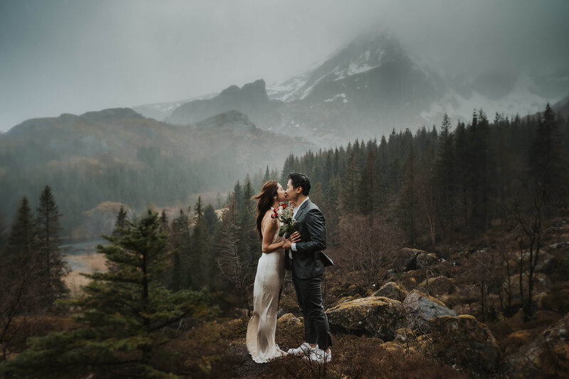 Elopement couple kissing on a mountain in Lofoten