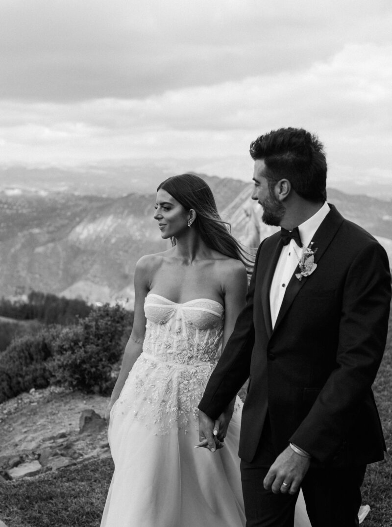 groom in tuxedo kissing bride