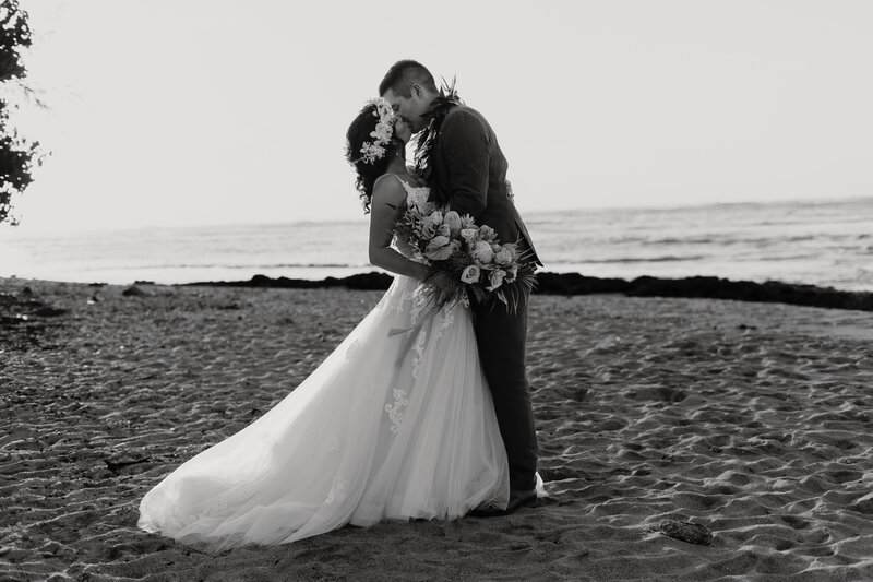 Bride and groom posing on Oahu, Hi, beach