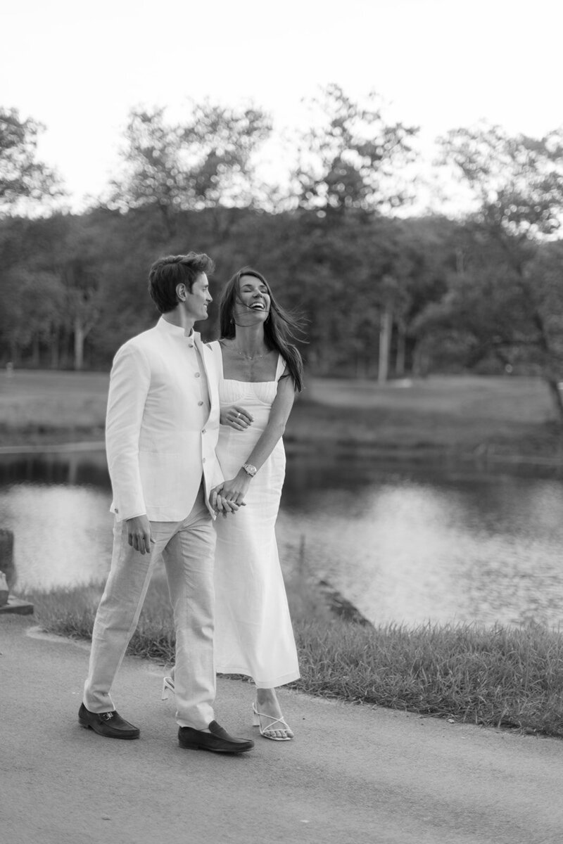couple walking next to water