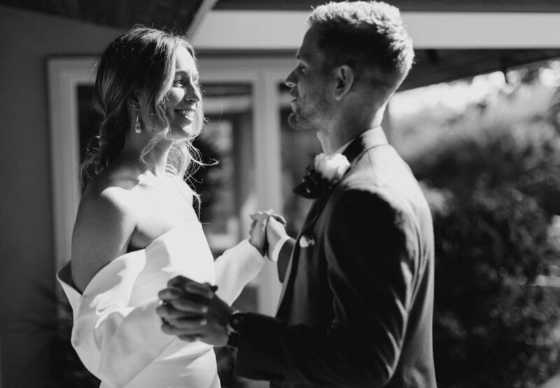 bride and groom holding hands