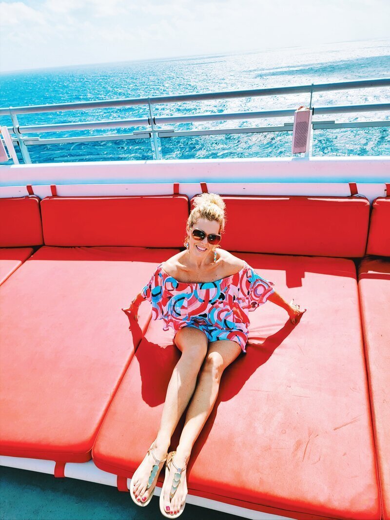 luxury travel concierge GG Mack sitting on a boat 