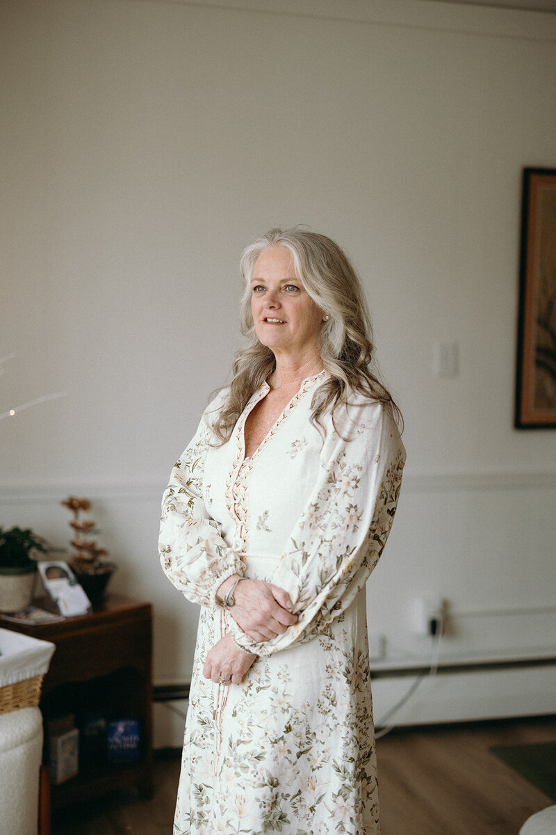 Janna Weldum of Eagle's Guiding Light looks out the window of her wellness center, The Eyrie Eagle's Guiding Light.
