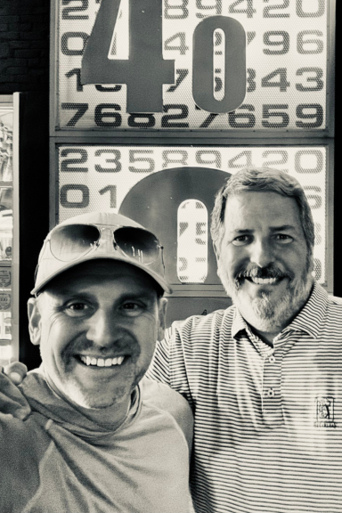 Lon Stroschein with community member Brad, smiling together during a Normal 40 Insider meetup