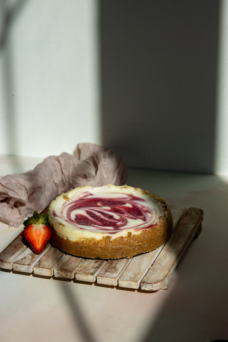 Strawberry cheesecake on wooden board