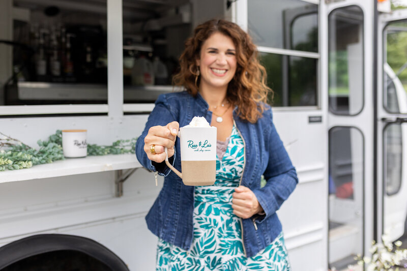 Rachel holding out a mug of coffee