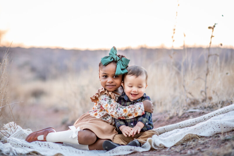 Siblings hold each other during photoshoot
