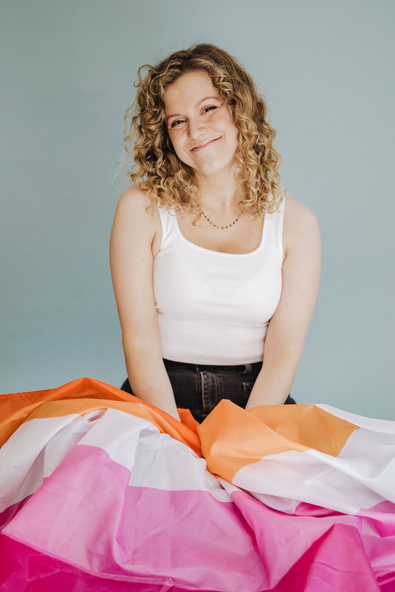 Megan Morris sits with the Lesbian flag in her lap