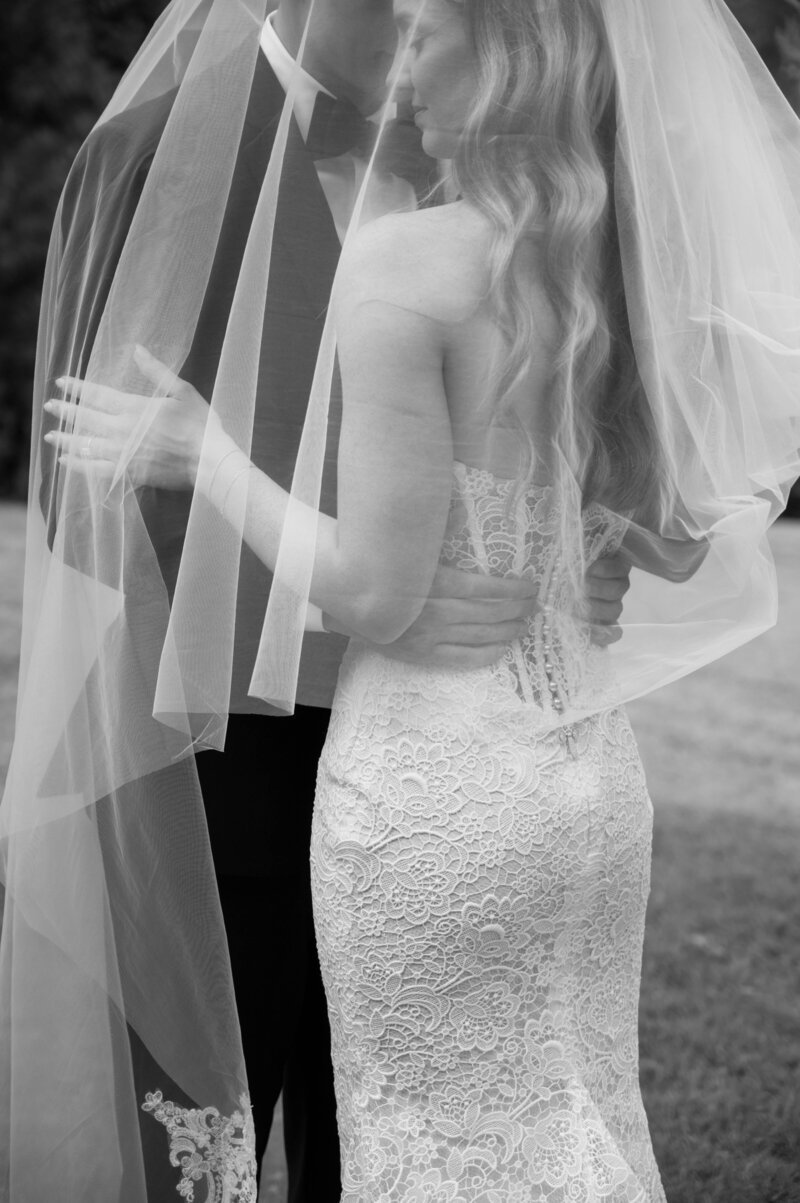 A couple on their wedding day getting married on the beach. They are in the middle of the ceremony.