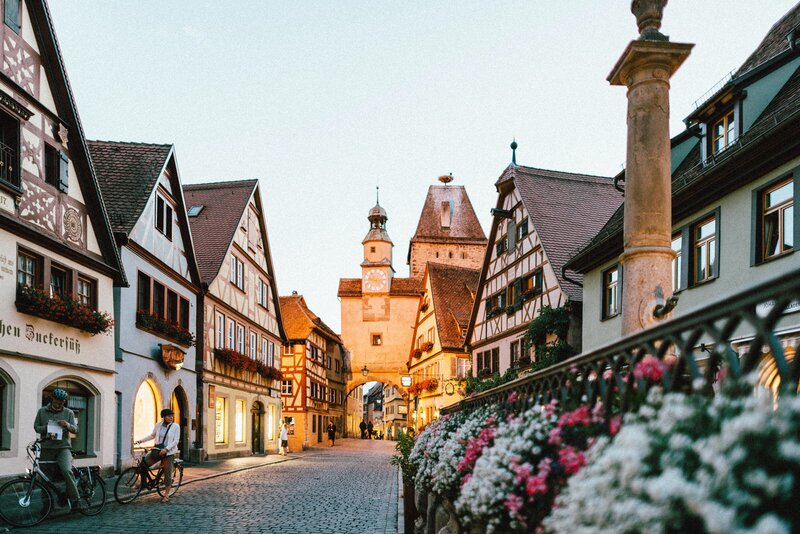 timber buildings in Strasbourg France with pink and white flower bushes