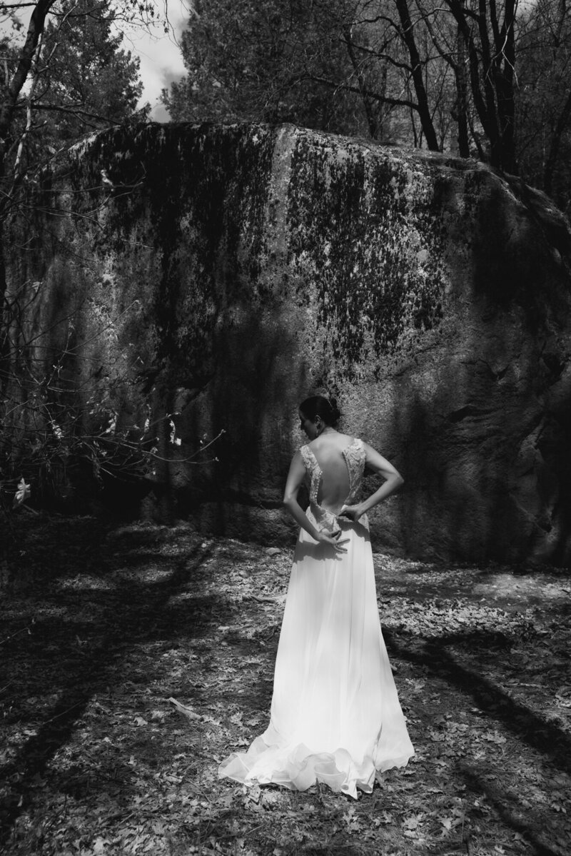 Bride walking through lush PNW forest with moss and towering trees