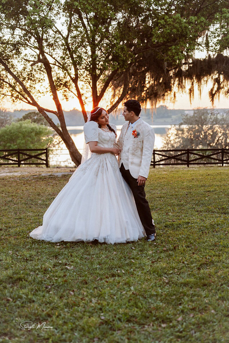 Bride and Groom during golden hour beside the lake under the Florida sky at Lakeview Gardens.