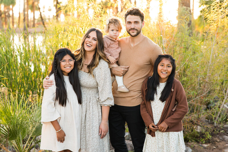 family smiling at camera in Phoenix