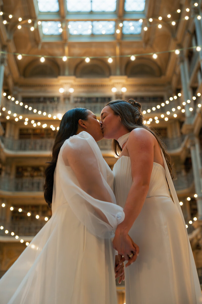A bride and dad hugging on her wedding day