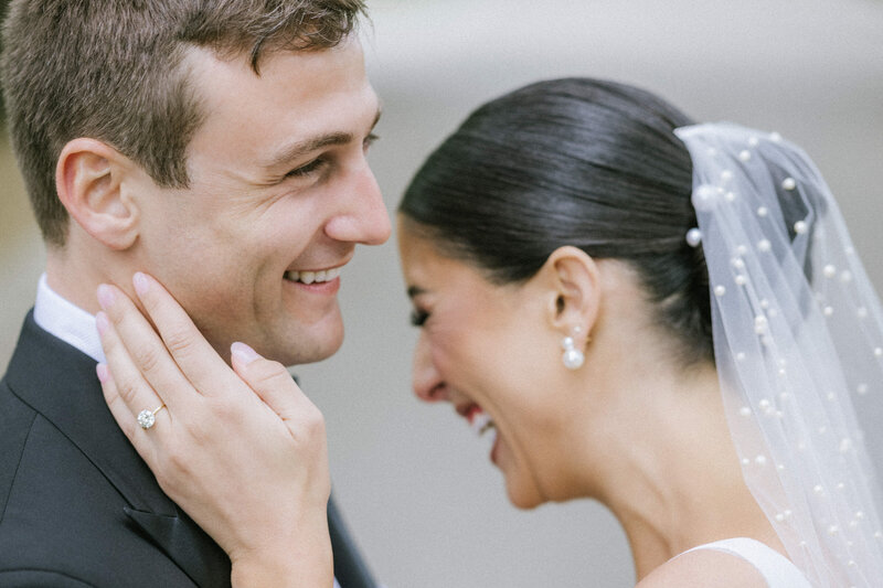 A couple laughing during their effortless spring wedding at Ashford Estate, captured in a candid, black-tie luxury style by an East Coast wedding photographer