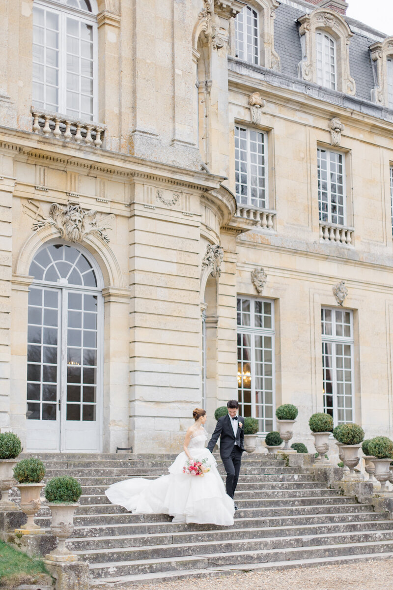 Bride and groom walking down a staircase