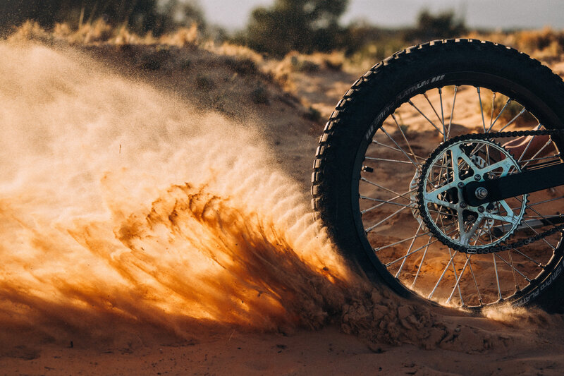 A Terra Bikes throws sand while spinning the rear wheel.