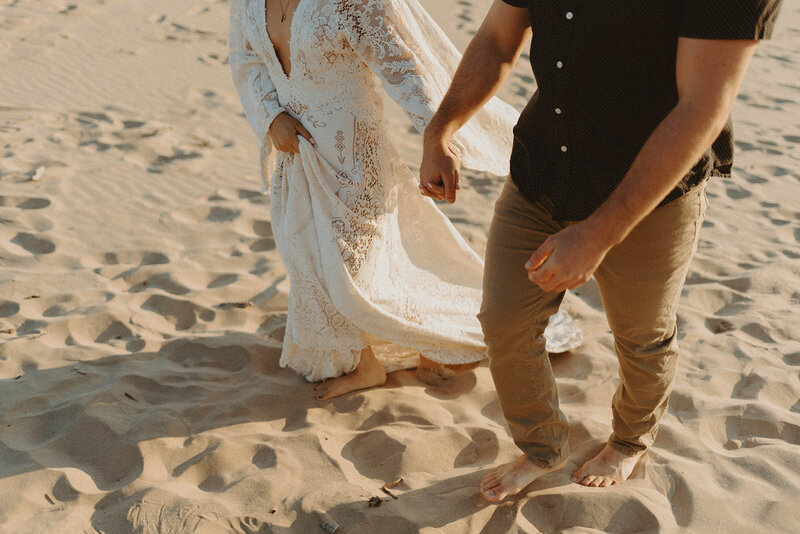 bride and groom walking across desert