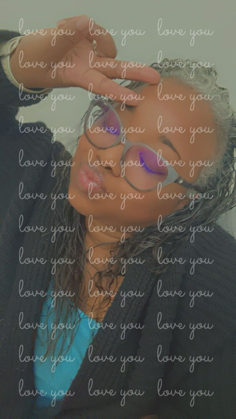 Letitia Hopkins with eyes closed, making a playful kissy face with 'love' written over the image, embodying self-love, confidence, and Main Character Energy as a life, love, and relationship coach guiding women into empowered, fulfilling lives and relationships.