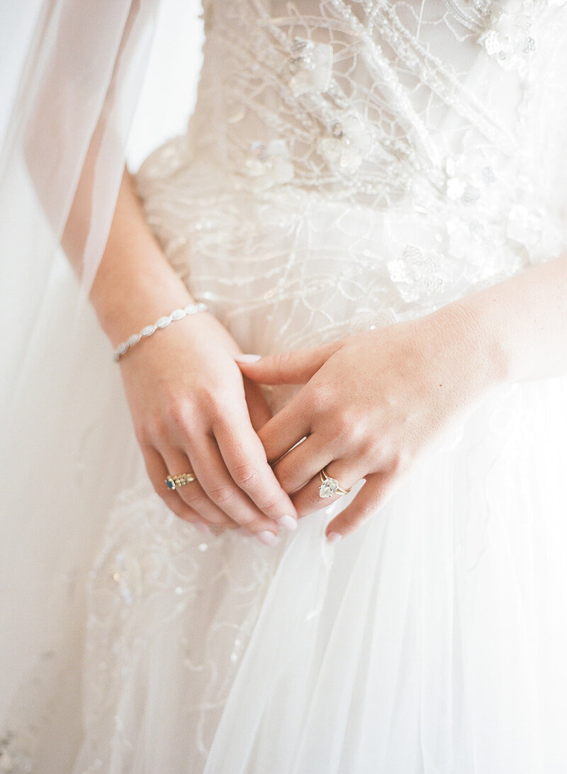 Hands of a bride in her wedding dress at her big day, planned by SF wedding planners Jacinda Weddings & Events.
