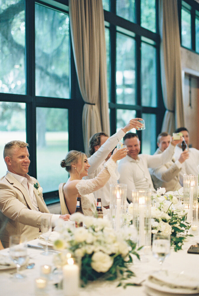 charleston couple toasting their glasses during the reception