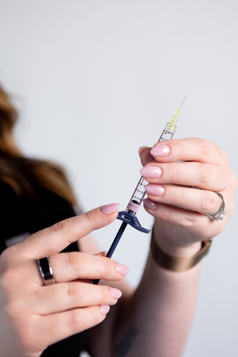 hands holding a syringe