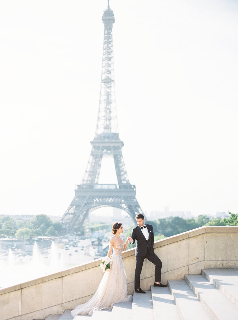 Bride and groom at Eiffel Tower in Paris for Paris destination wedding