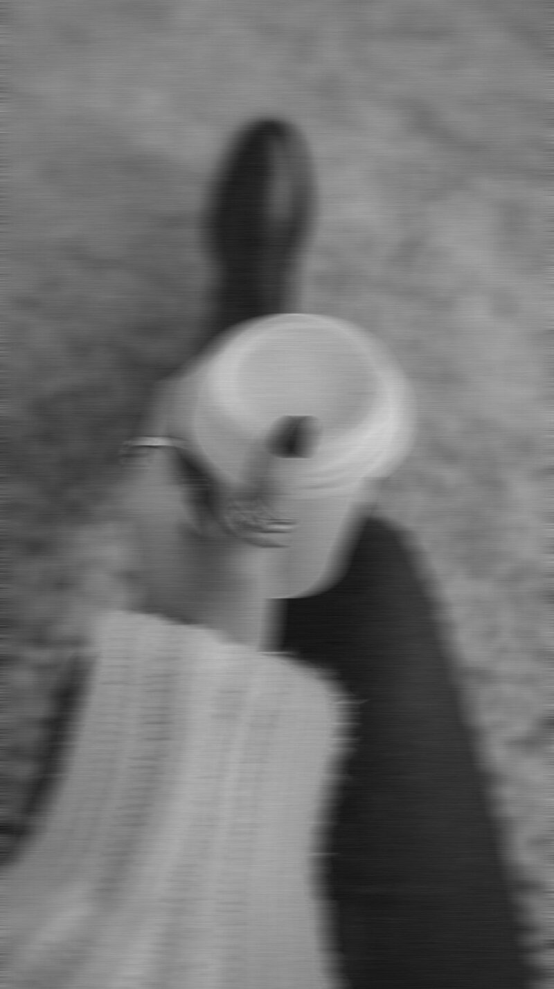a womans arm holding a coffee cup with a walking in motion shot