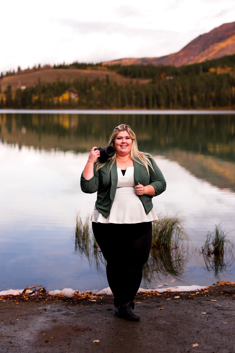 Edmonton wedding photographer branding photo, she is looking at the camera smiling, gorgeous mountain and lake in the background