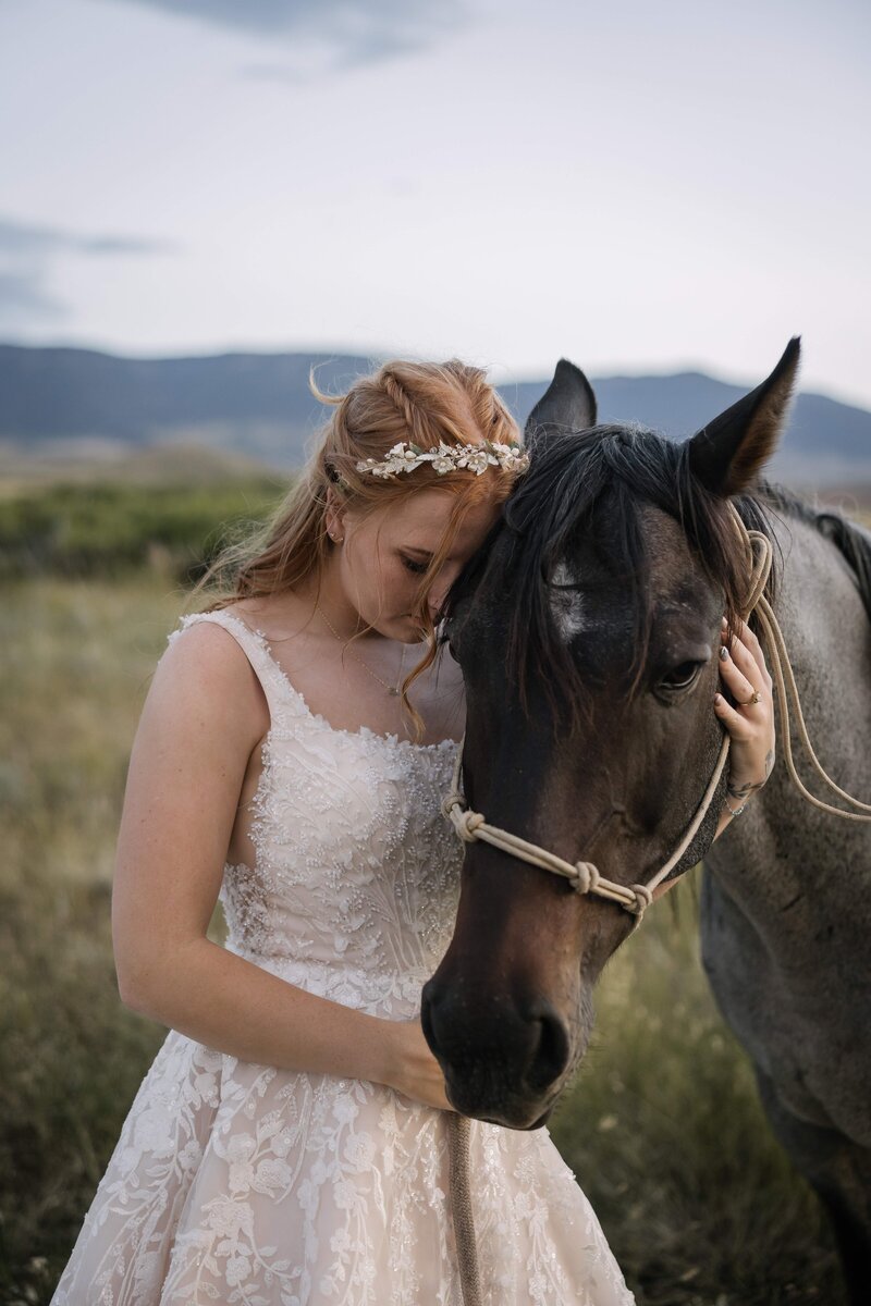 bride with her horse in summer wedding