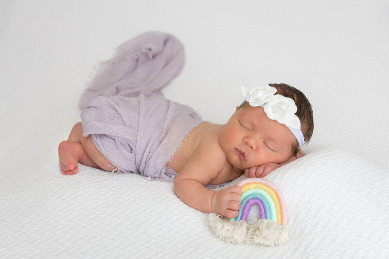 A newborn baby sleeping for newborn photography photos in midland michigan