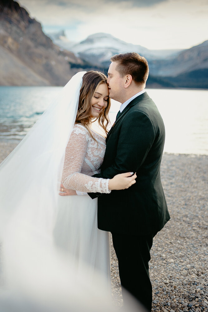 Couple shown holding hands during their hiking elopement on west wind pass  near Canmore, AB