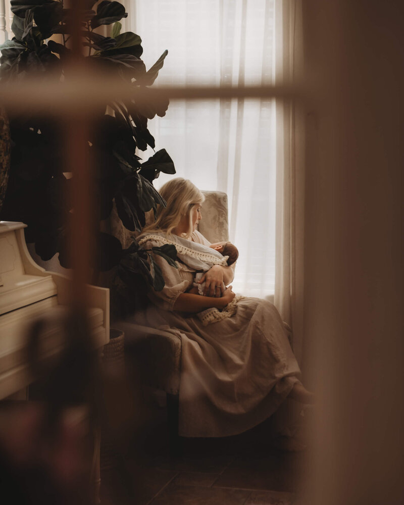 Baby swaddled in neutral tones with soft textures in a calm setting