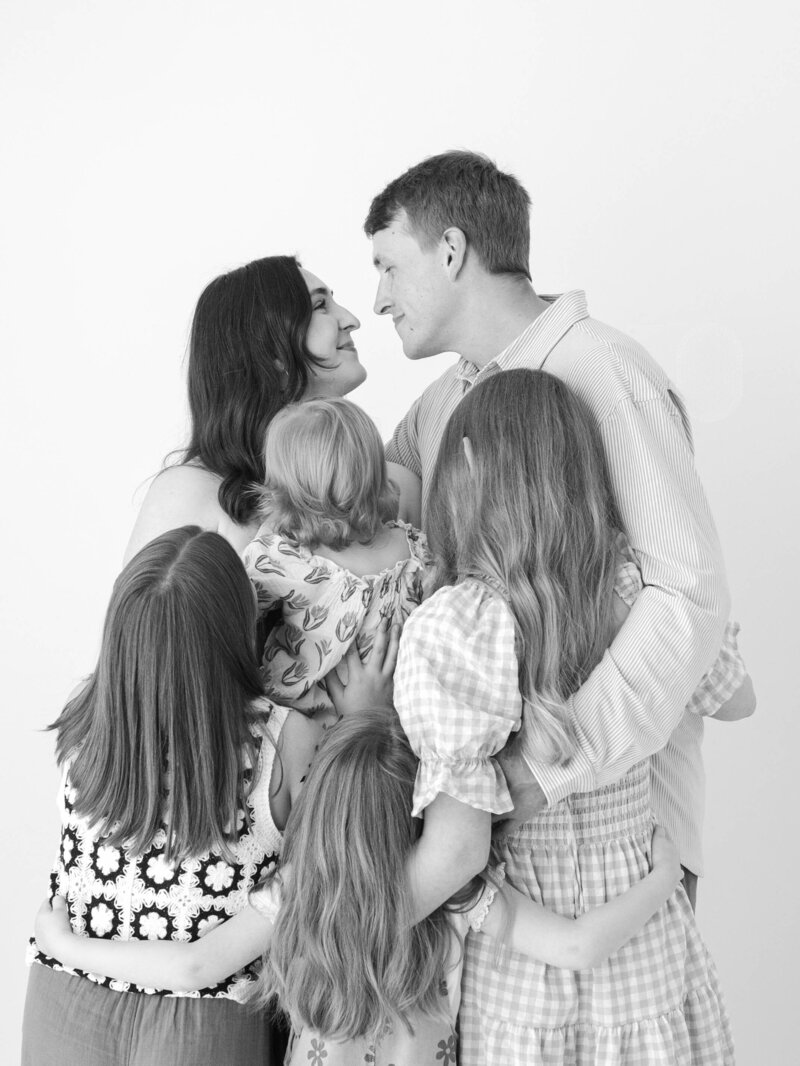 Picture of mom and dad with 3 kids staring over the mountains