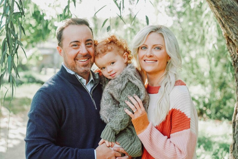 mother and father holding child