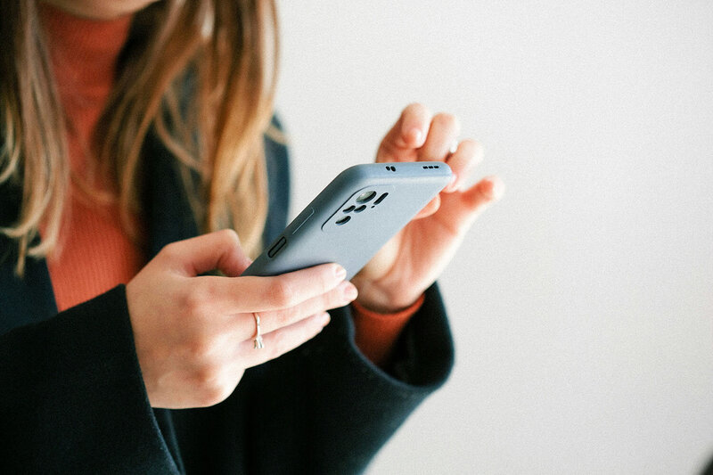 Stock image of a woman's hands using a smart phone. 