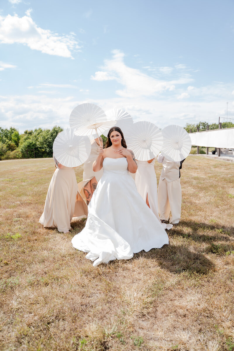 Bride and groom dip kissing halfway down the isle with their family and friends smiling on them