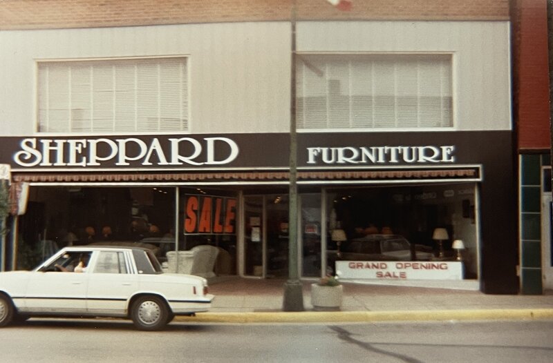 Old image of Sheppard Furniture store. Discover conscious style through sustainable jewelry and thrifting through our roots