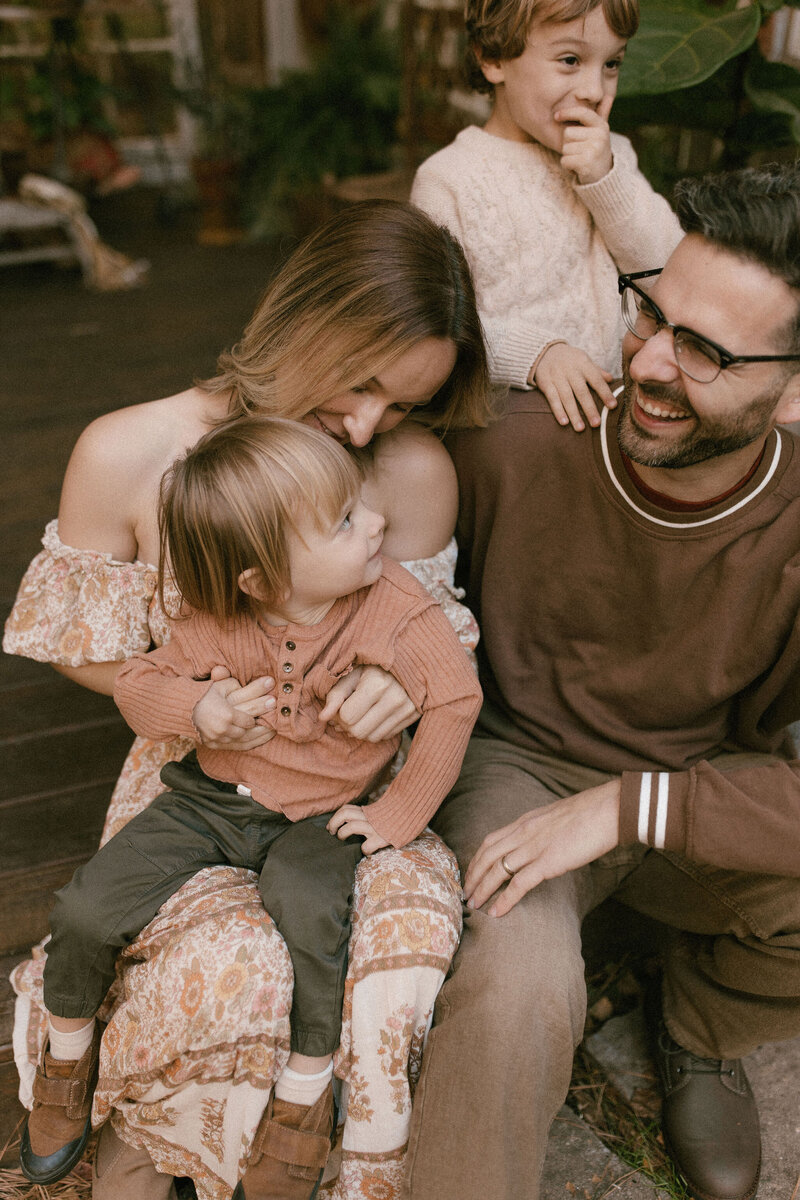 A family sit together and laugh. 