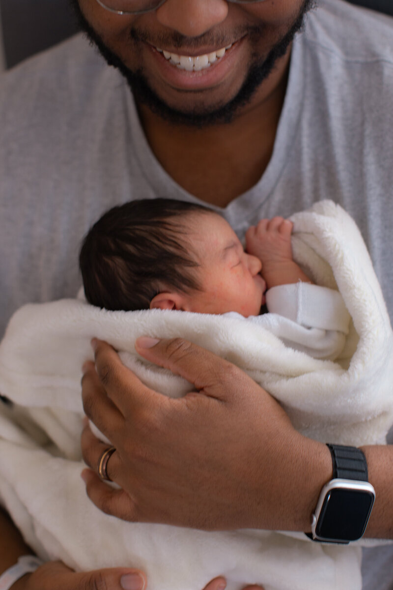 New dad holding his newborn girl