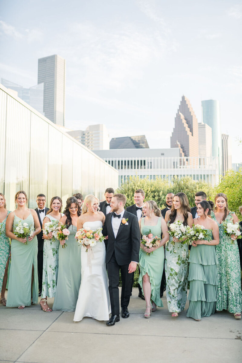 Houston wedding planner leaning on a green couch.