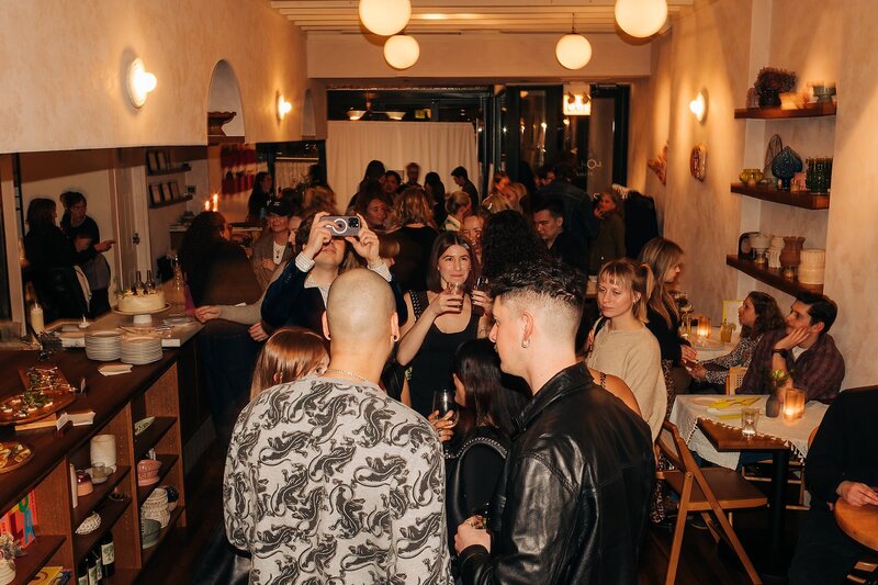 Friends toasting and celebrating during Dart Collective Chicago launch at Lou Lou by Lola Cafe